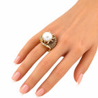 18K yellow gold ring with pearl and champagne diamonds on a hand