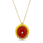 Gold necklace with carved red-orange coral face pendant and diamond accents