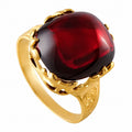 18k yellow gold ring with red garnet cabochon and ornate bezel prongs