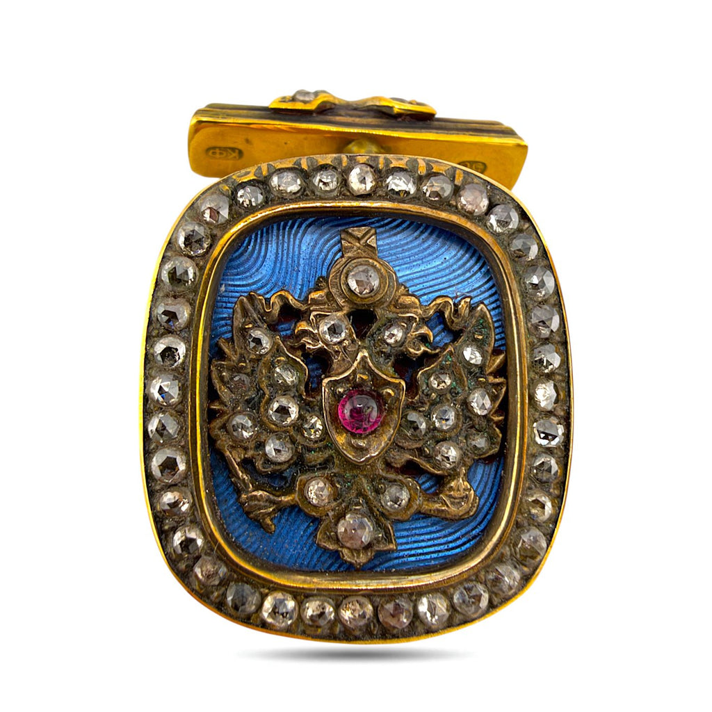 Faberge gold cufflink with blue enamel, ruby center and diamond border