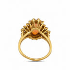 Back view of yellow gold gemstone ring with open prongs and round center stone