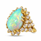 Yellow gold pear-shaped opal ring with diamond accents