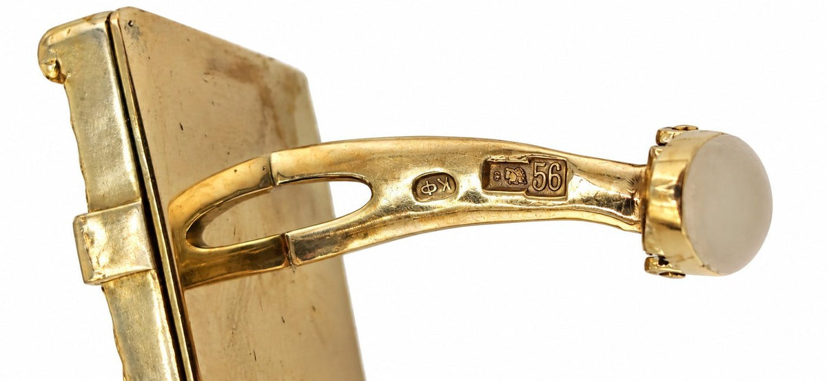 Gold cufflink clasp with oval button, engraved '56', and hinged frame