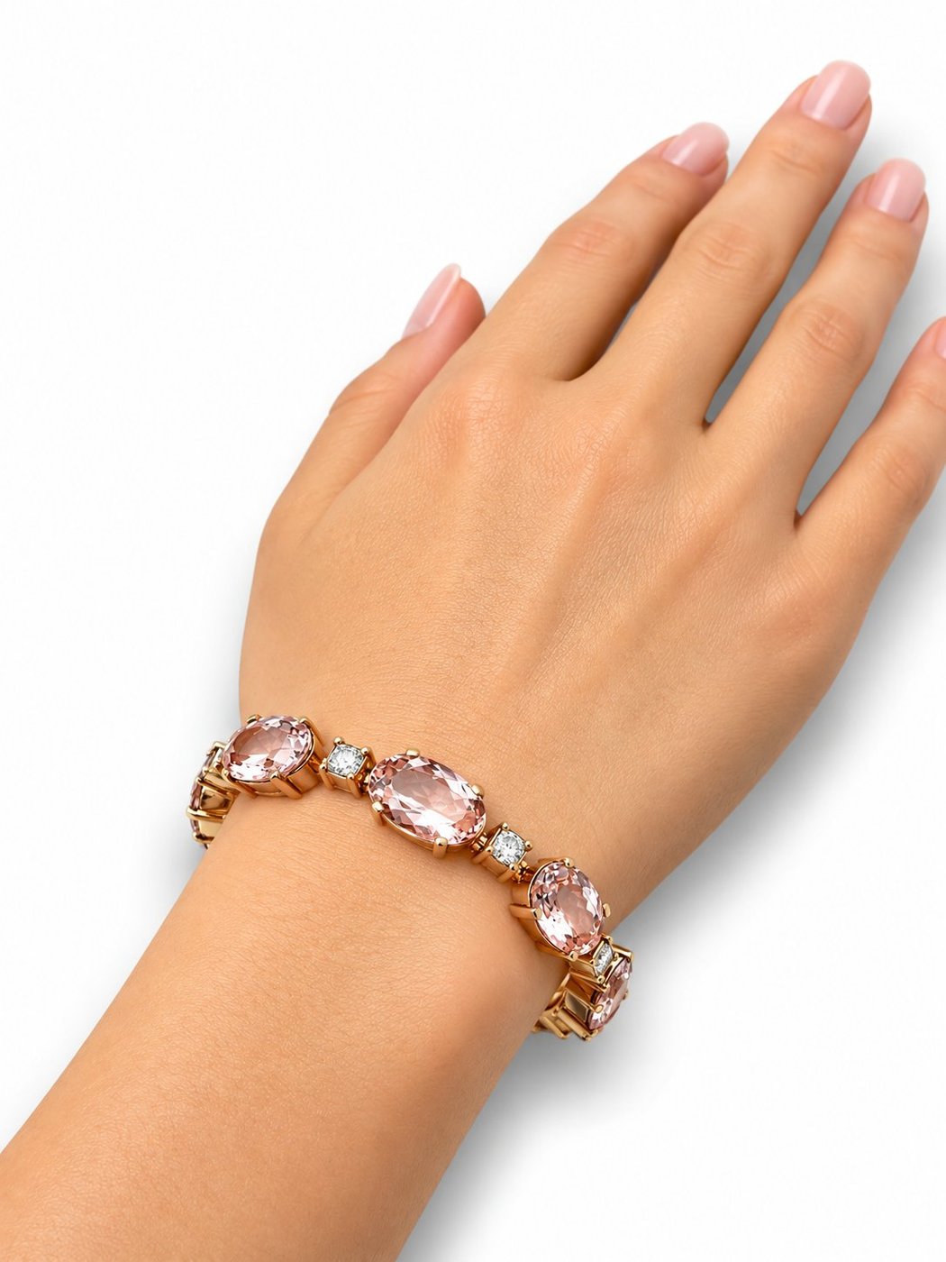 Rose gold bracelet with oval pink stones and diamond accents on an open hand