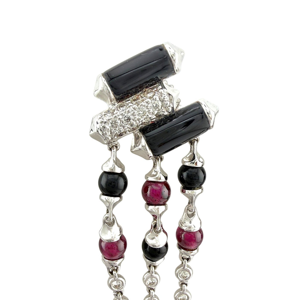 White gold dangle earrings close-up with black rectangular stones, ruby and onyx beads