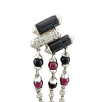 White gold dangle earrings close-up with black rectangular stones, ruby and onyx beads