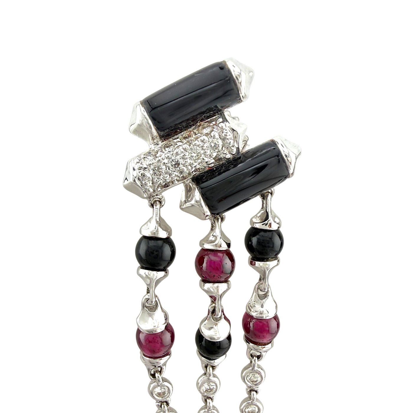 White gold dangle earrings close-up with black rectangular stones, ruby and onyx beads