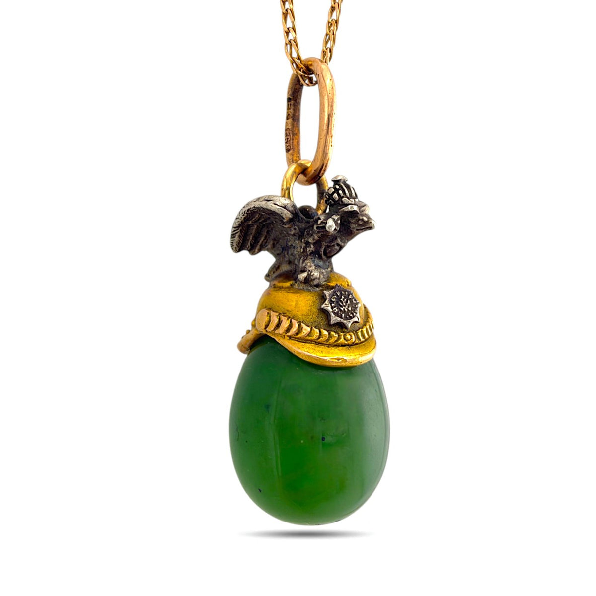 Green nephrite egg pendant with a gold cap and sculpted eagle finial