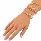 Rose gold butterfly bracelet worn on the wrist, featuring pearl inlays and diamonds