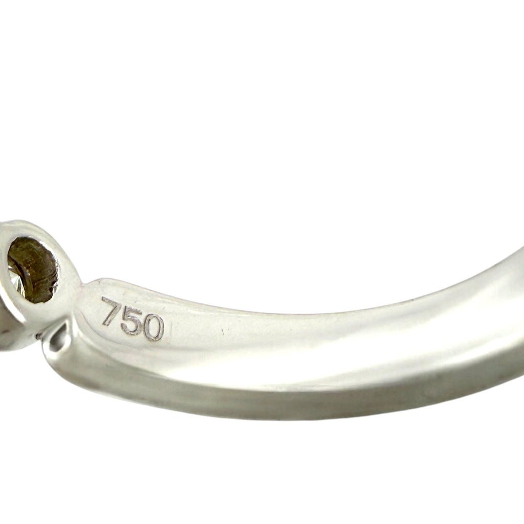 750 hallmark on white gold ring band, polished metal with prong base detail