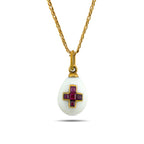 White egg pendant necklace with a gold-tone setting and ruby cross