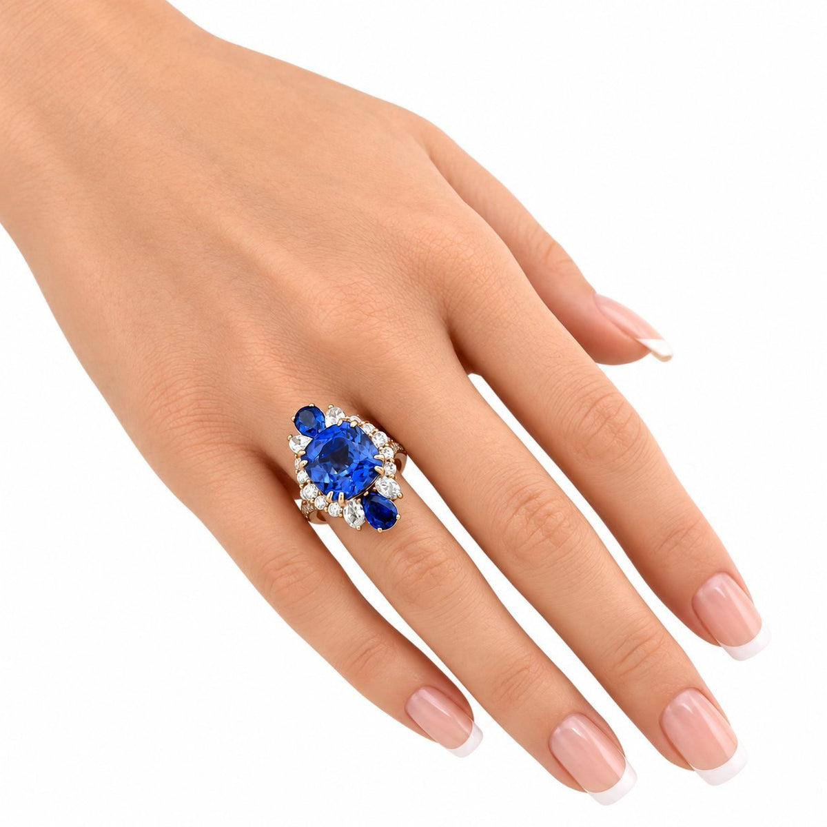 Blue sapphire-style and diamond ring on finger with rose-gold band