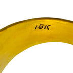 Close-up of the ring's inner band stamped 18K