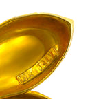 Close-up of the gold earring interior with a stamped hallmark