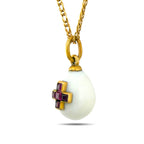 Angled view of egg pendant showing the raised ruby cross setting
