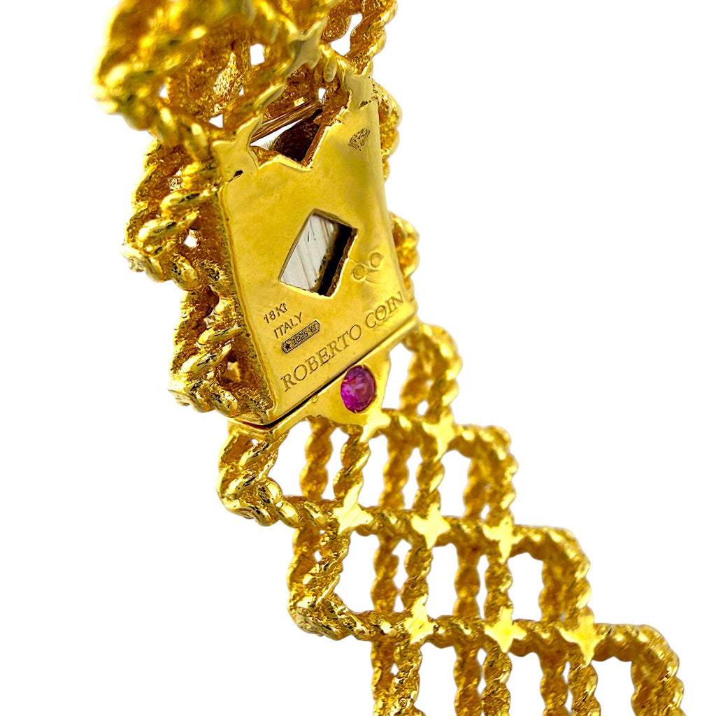 Roberto Coin gold bracelet close-up with openwork links and diamond-set details