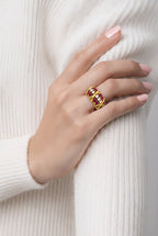 Gold ruby and diamond band ring worn on hand