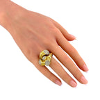 Sculptural yellow gold ring with diamond clusters worn on a hand
