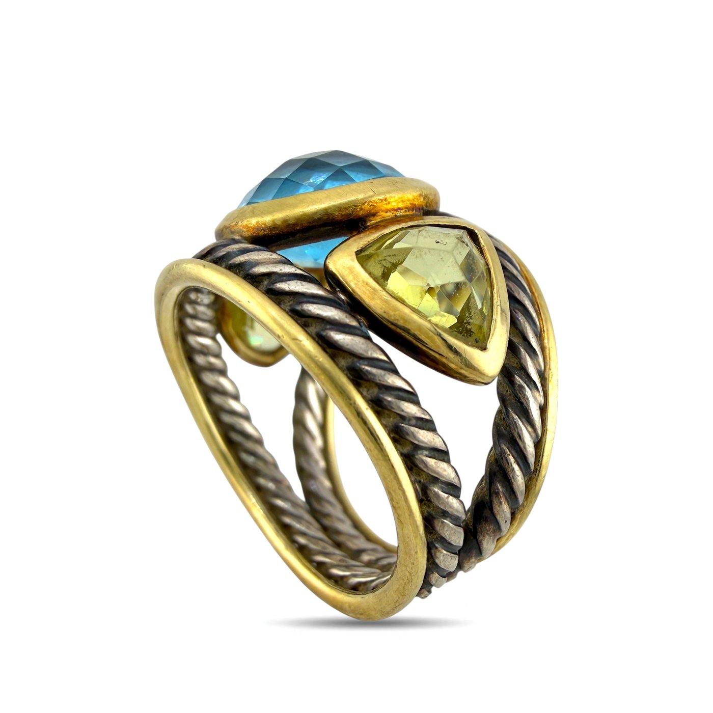 Angled view ring with oval blue topaz top and yellow side stone set in gold