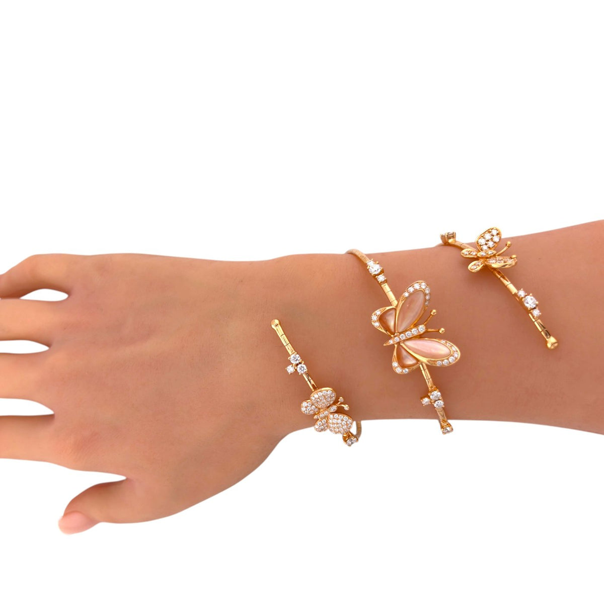 Rose gold butterfly bracelet on the wrist, showing its three jeweled motifs