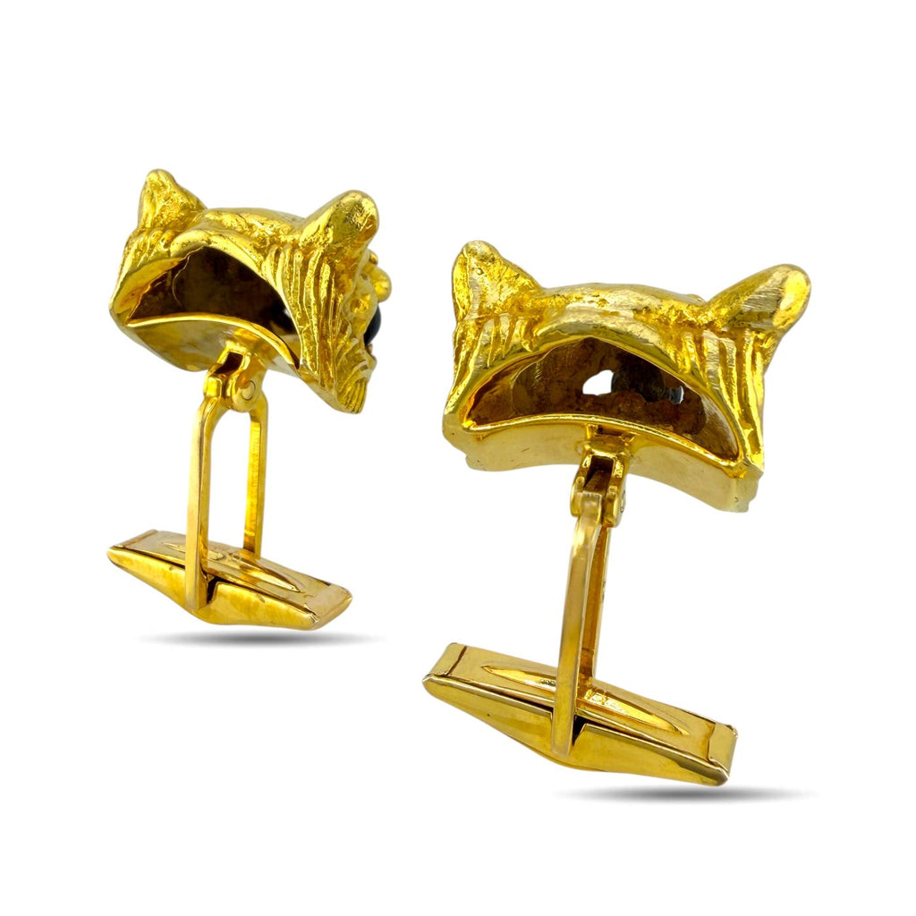 Gold panther cufflinks from side view with dark stone eyes and diamond highlights