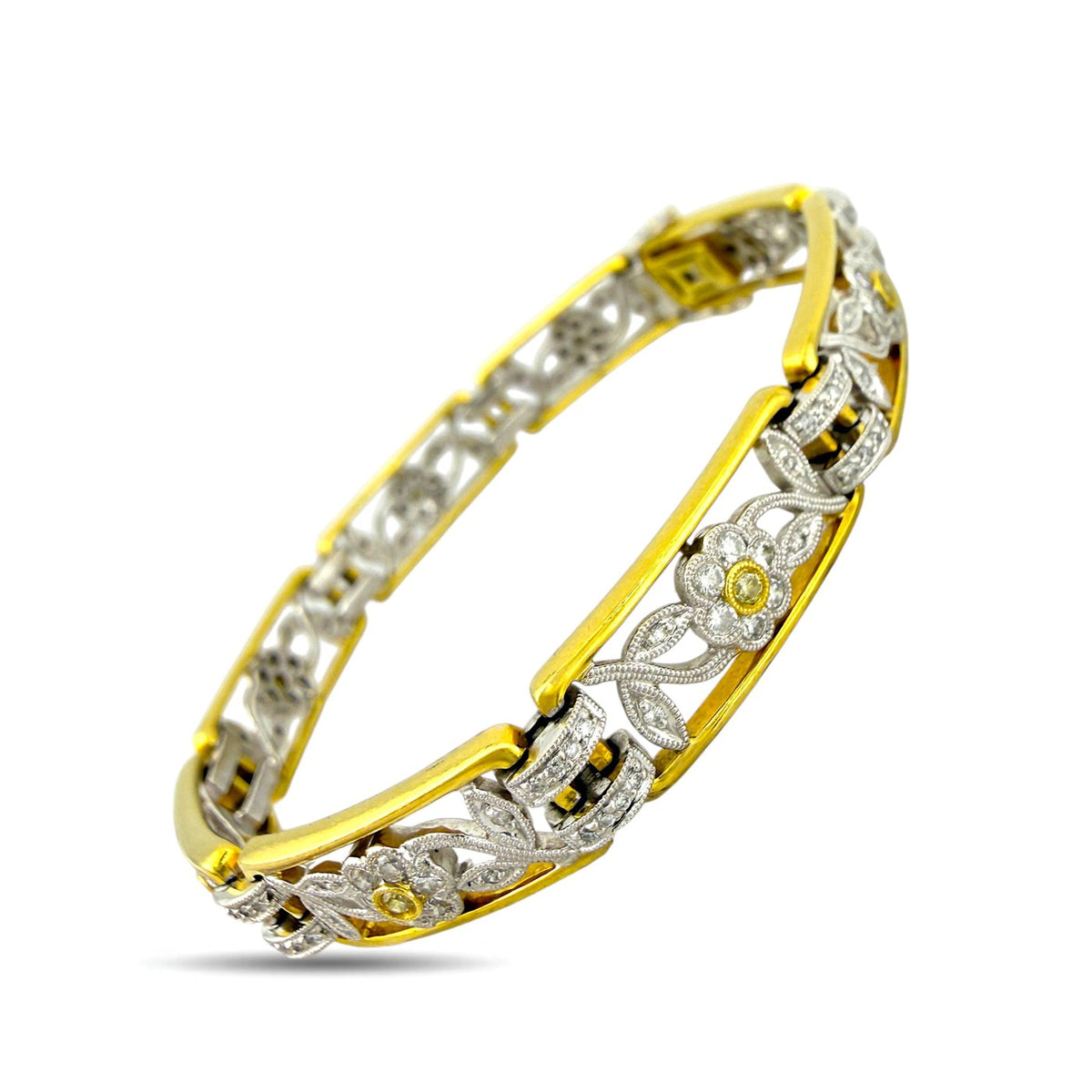 Close view of two-tone gold diamond floral bracelet with openwork link details