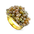 Gold cocktail ring with clustered multicolor faceted gemstones and scalloped band