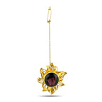 Gold sunburst brooch with round dark amethyst stone, on a chain