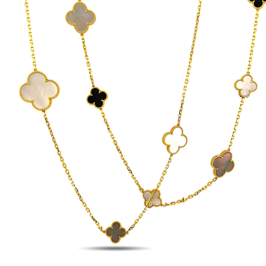 Long gold necklace featuring repeating clover charms in white mother-of-pearl and black onyx