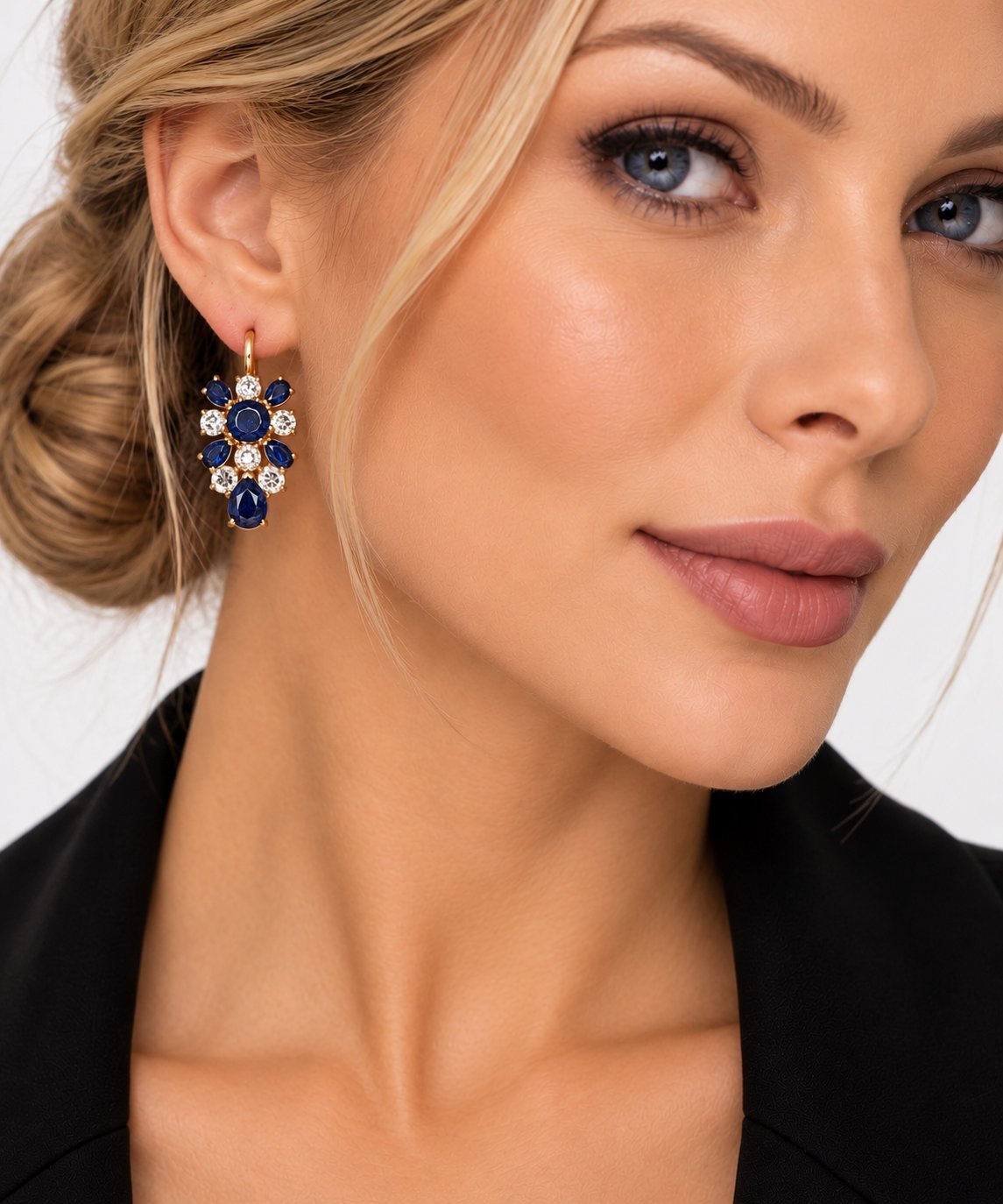 Model wearing K. Faberge rose gold sapphire and diamond floral drop earrings