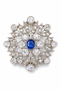 Snowflake brooch in 18K white gold with blue center stone and diamond-like accents