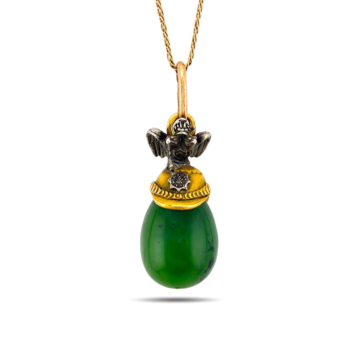 Green nephrite egg pendant with a decorated gold cap and eagle finial, front view