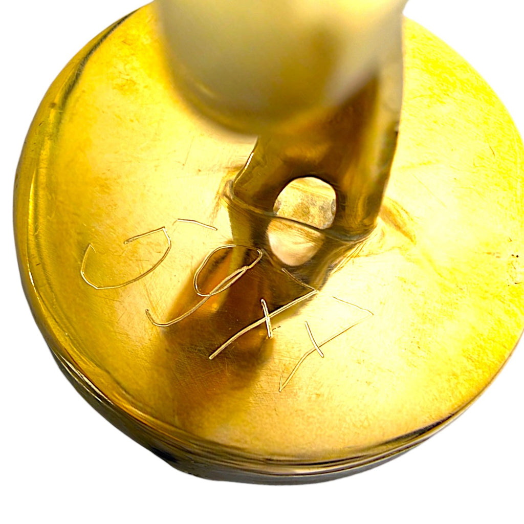 Gold cufflink back with clasp loop and engraved detailing, close-up view