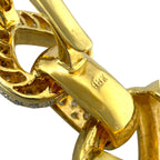 Close-up of yellow gold bail and connector with textured setting