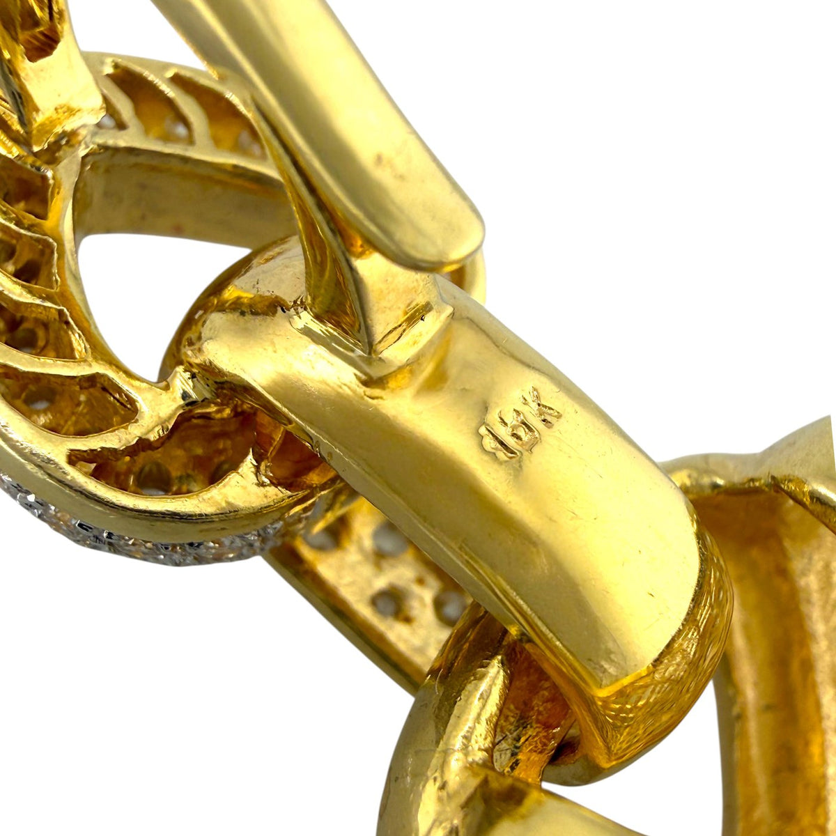 Close-up of yellow gold bail and connector with textured setting