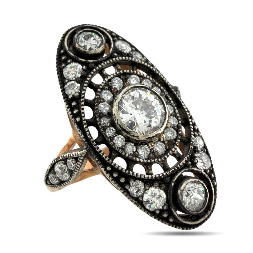 Oval center diamond in black filigree ring with round halo accents and side stones