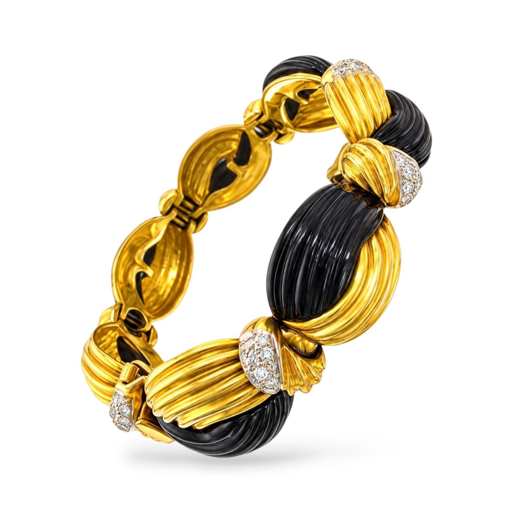 18K yellow gold bracelet with black onyx links and diamond accents, shown at an angle