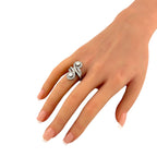 18K white gold diamond ring with swirl design on a hand