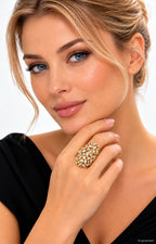 18K yellow gold diamond statement ring with oval cluster design on a hand