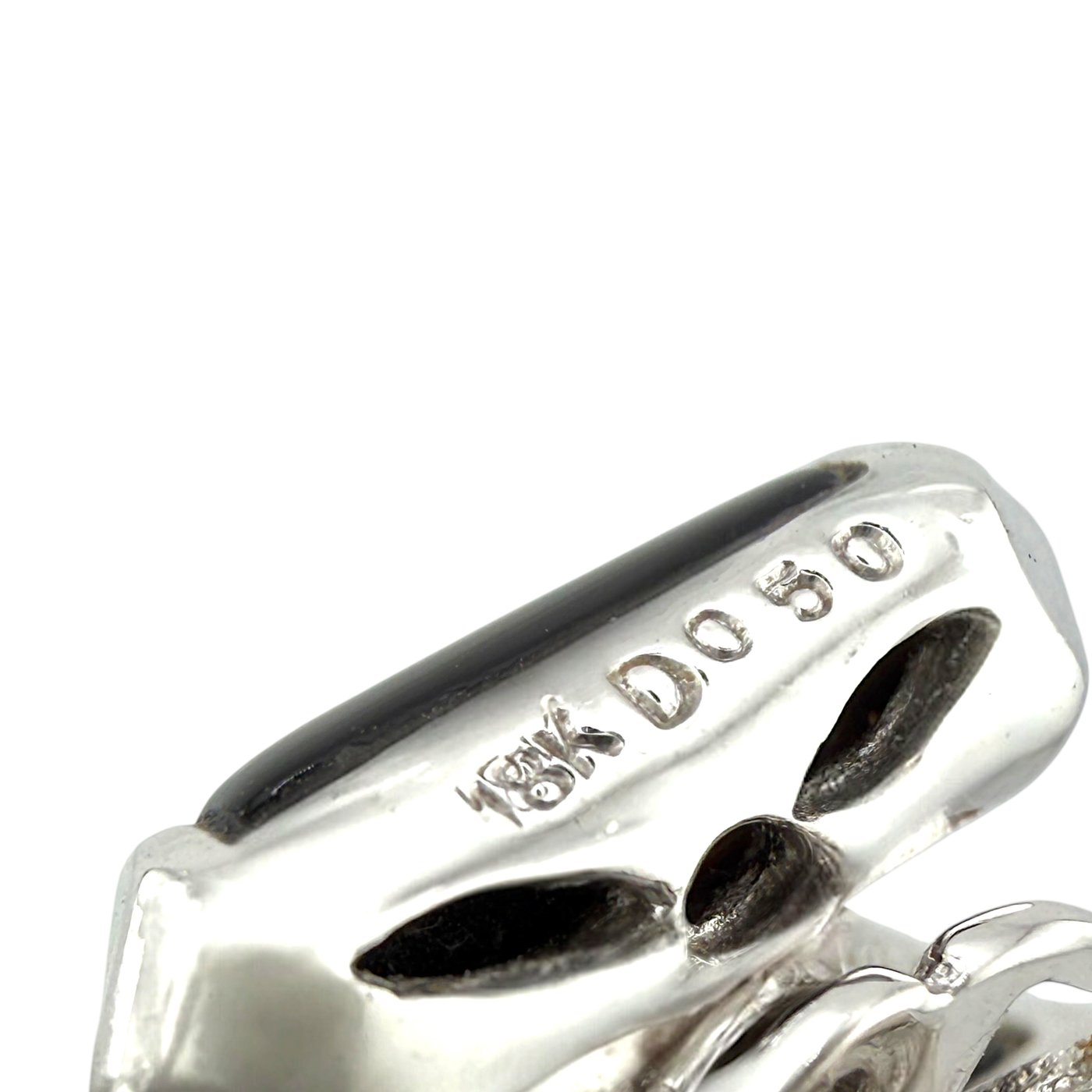 White gold earring detail with metal hallmark and black gemstone setting