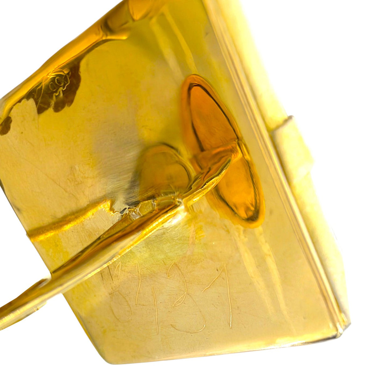 Gold cufflink back with polished metal finish and engraved marks