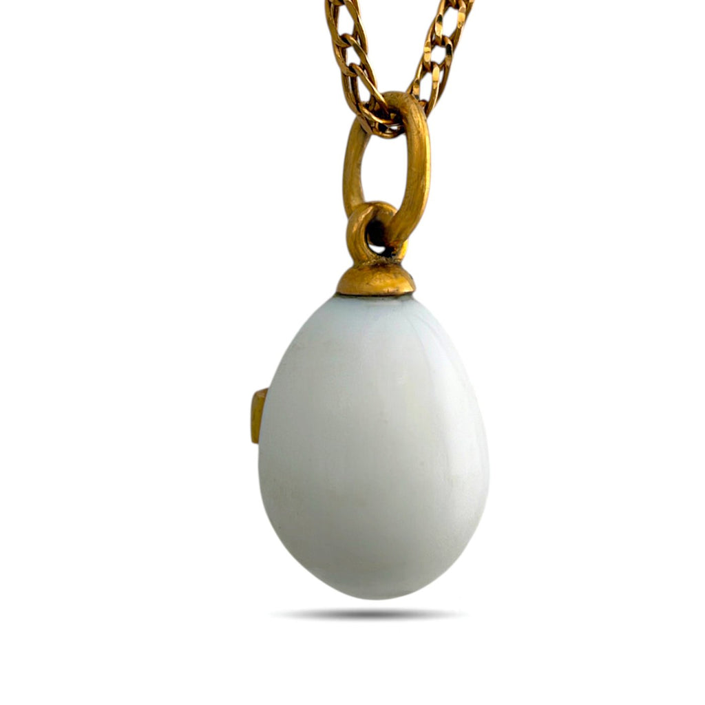 Back of white egg pendant with a gold-tone bail