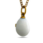 Back of white egg pendant with a gold-tone bail