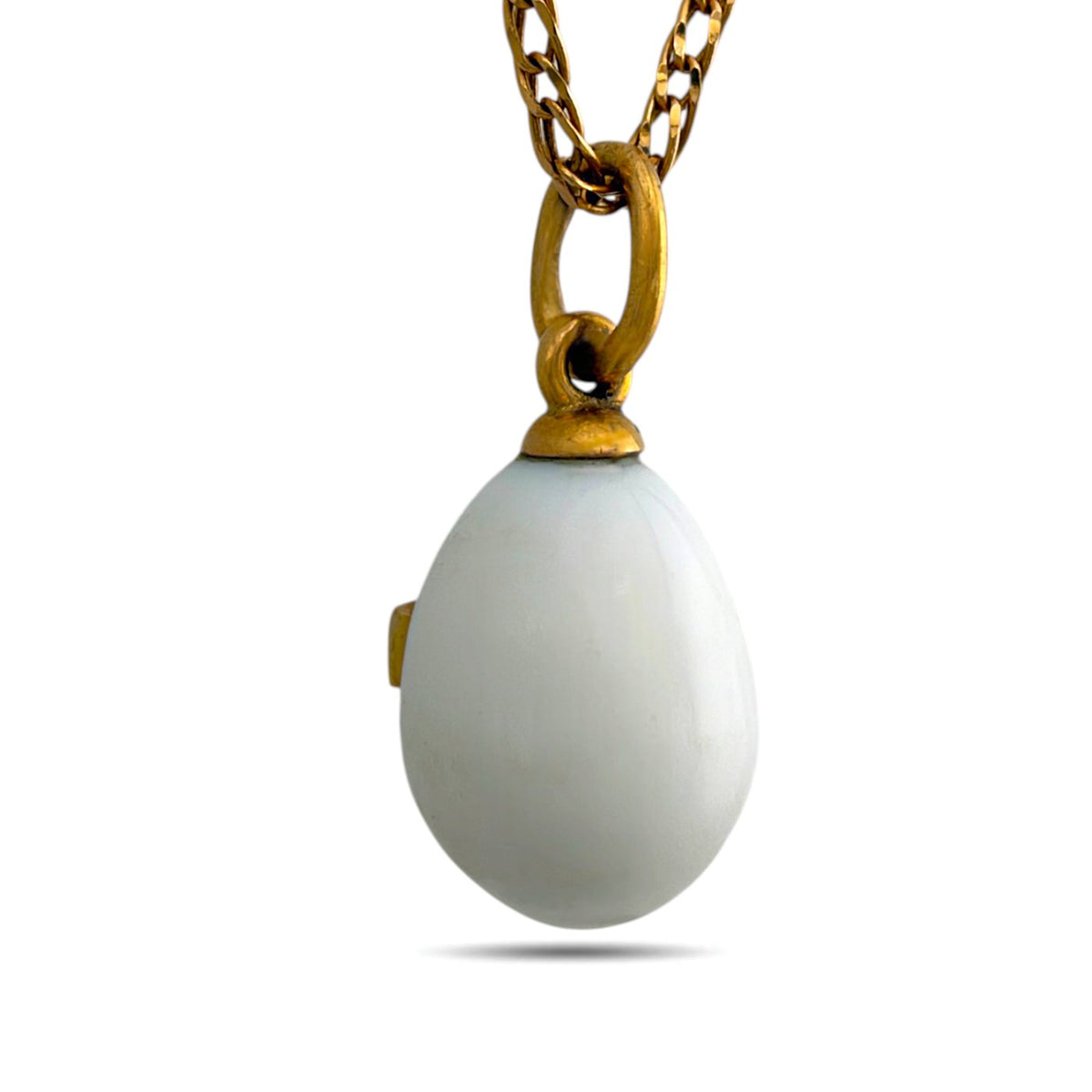 Back of white egg pendant with a gold-tone bail