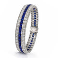 Platinum bracelet with diamond pavé and blue gemstone rows, arched profile view
