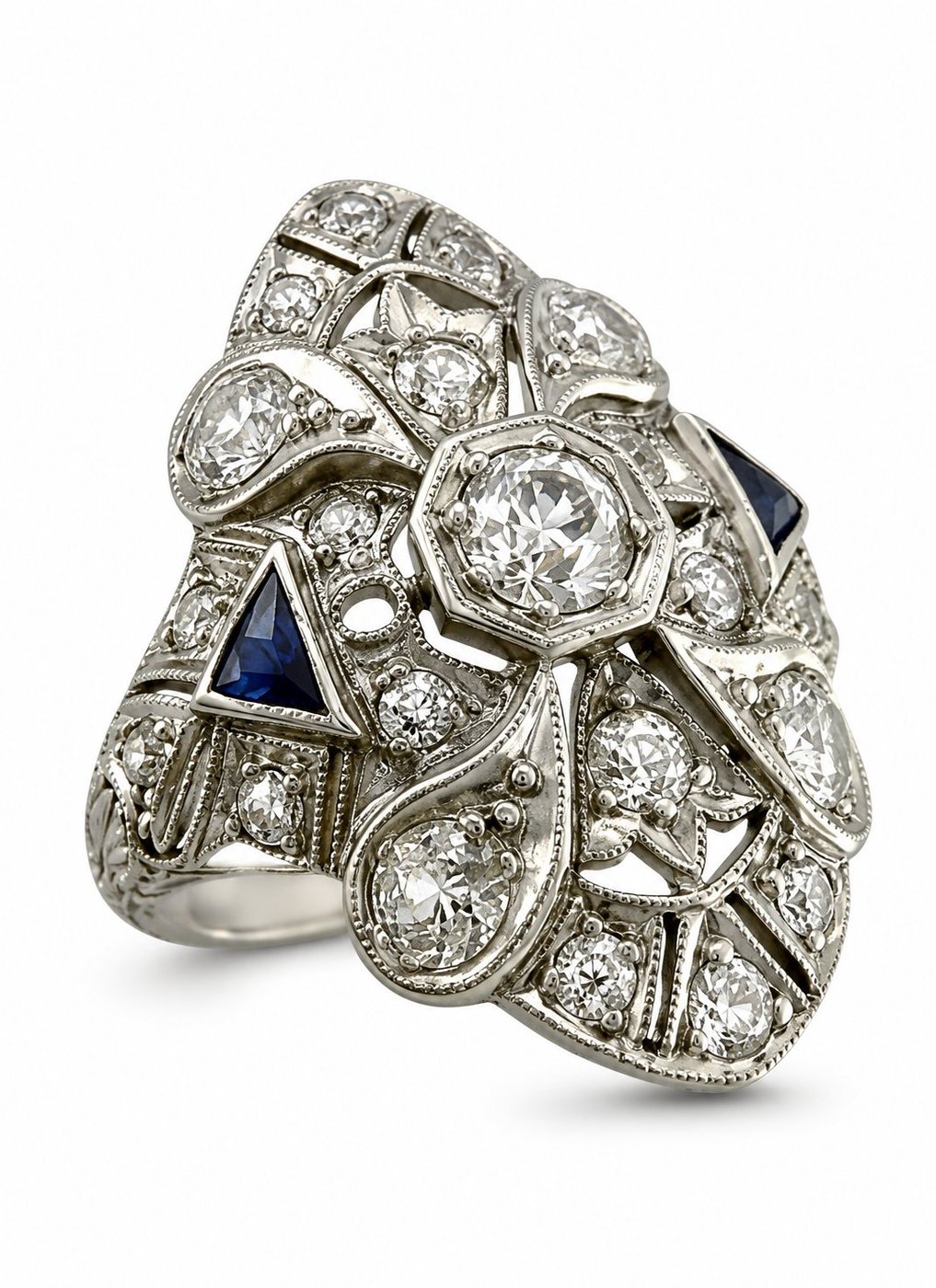 Art Deco diamond and sapphire ring with round center stone and blue side accents, platinum-tone