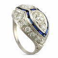 Platinum art deco diamond ring with blue sapphire accents and openwork gallery
