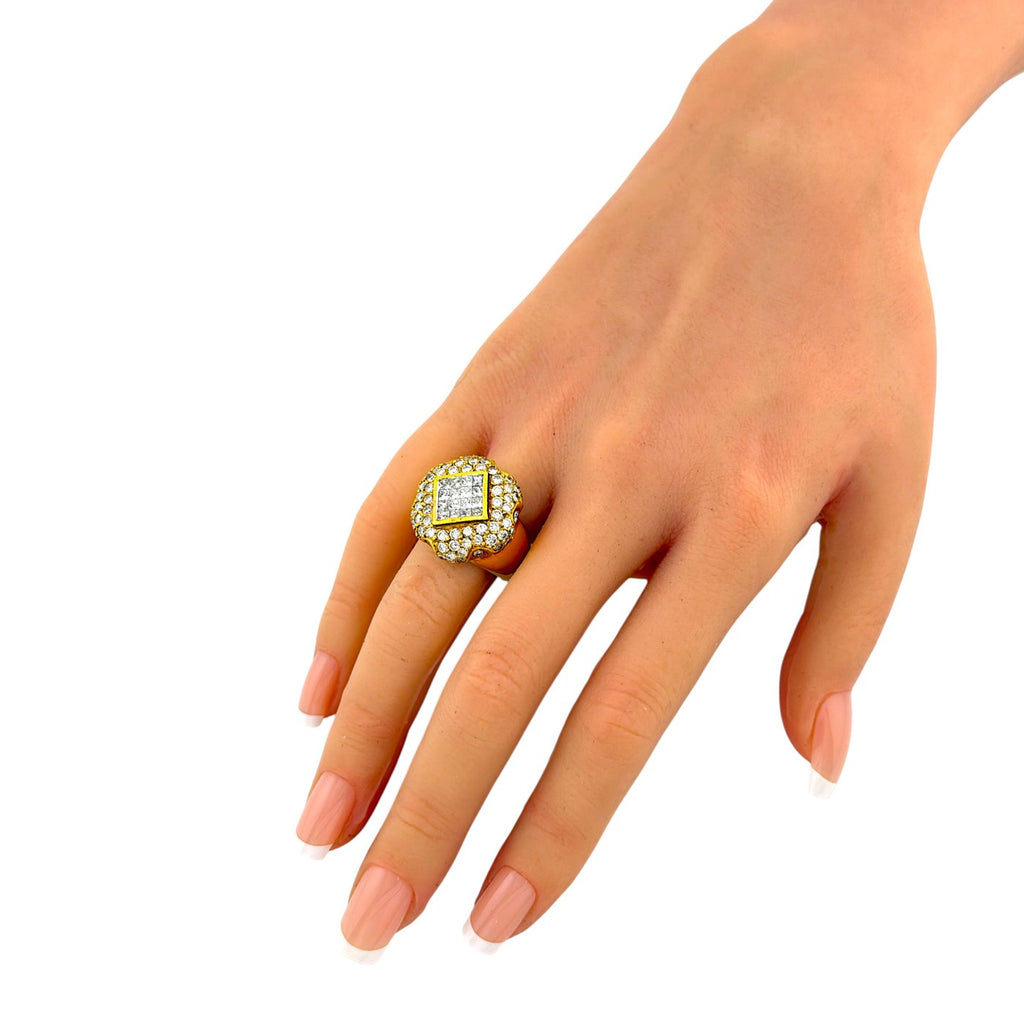 Yellow gold diamond ring shown on hand, with a square center stone
