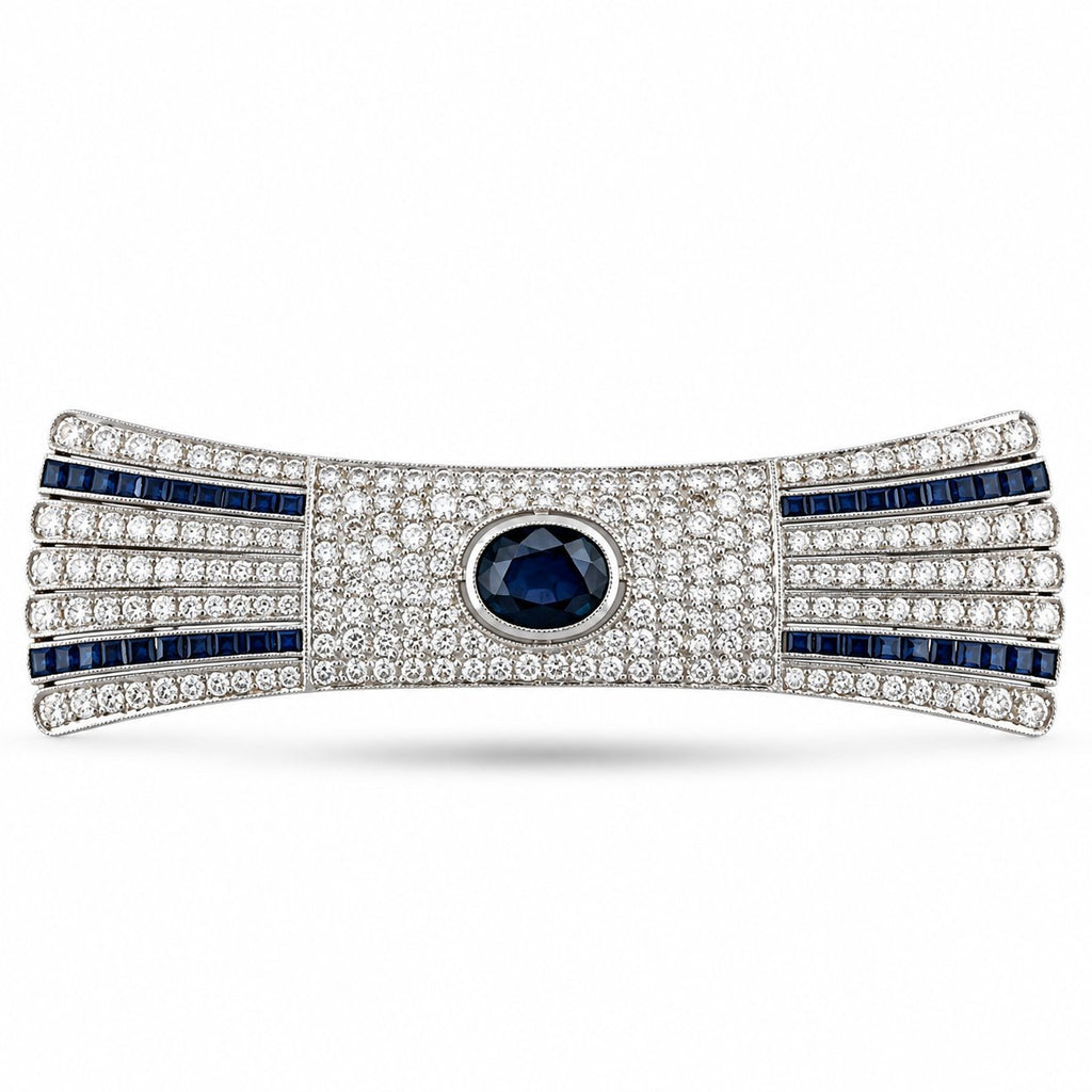 Art deco diamond and sapphire bar brooch with oval blue center stone and blue striped accents