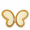 Yellow gold butterfly pendant with white coral wings and a central round diamond